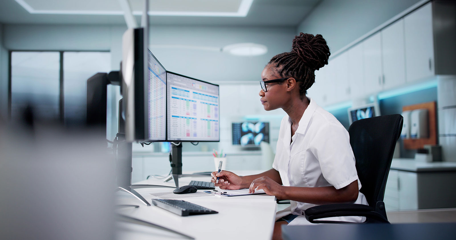 Office worker doing computer work in ergonomic workspace